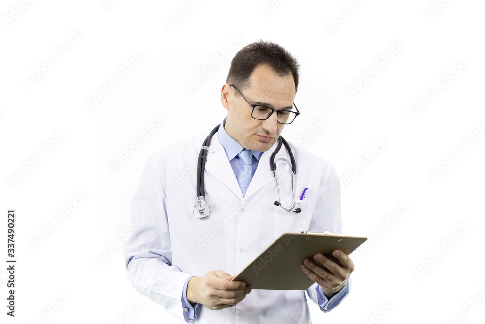 Tired male senior age doctor in white coat and stethoscope looking on clipboard with patient's diagnosis on isolated white background. Copy space. Healthcare, insurance, diagnosis, medical concept Tired male senior age doctor in white coat and stethoscope looking on clipboard with patient's diagnosis on isolated white background. Copy space. Healthcare, insurance, diagnosis, medical concept