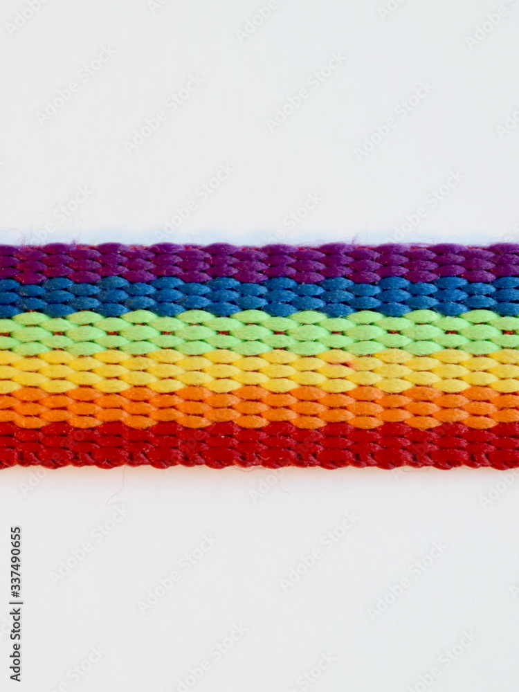 Gay pride LGBT rainbow ribbon isolated close up on a white background.