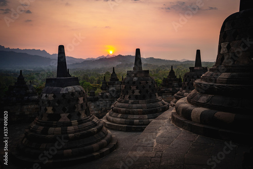 sunset over stupas of borobudur indonesia