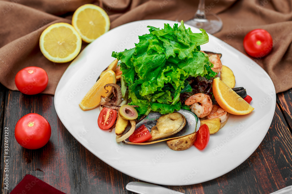 salad with seafood, with mussels and shrimps on a wooden background
