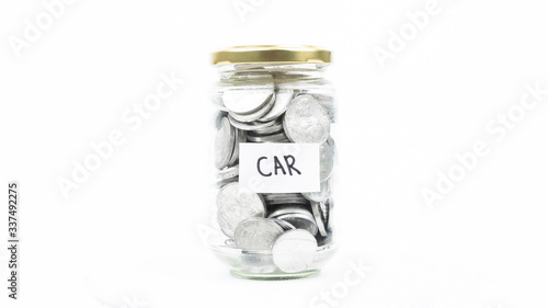 Jar full of coins with a car text