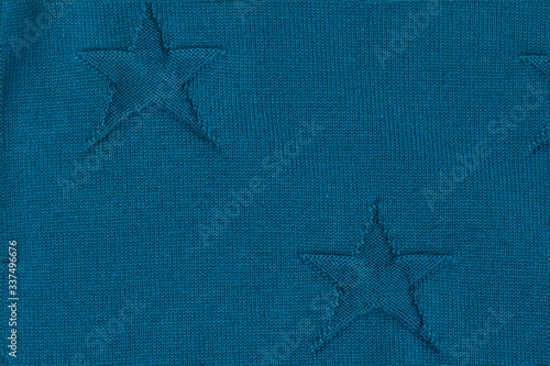Blue knitted textured background with stars