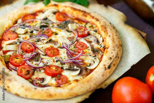 pizza with mozzarella cheese with tomatoes red onion and tenderloin