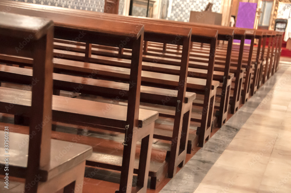 Detail of wooden benches inside a church Detail of wooden benches inside a church