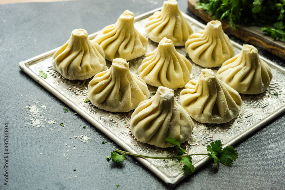 Traditional georgian khinkali dish on stone background Traditional georgian khinkali dish on stone background