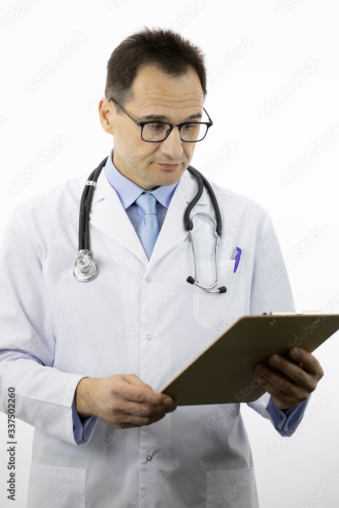 Smart male senior age doctor in white medical coat and stethoscope looking on clipboard with patient's medical diagnosis on isolated white background. Close up. Health, insurance, medical concept Smart male senior age doctor in white medical coat and stethoscope looking on clipboard with patient's medical diagnosis on isolated white background. Close up. Health, insurance, medical concept
