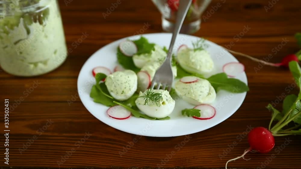 boiled stuffed eggs with green cheese filling with arugula leaves and radish boiled stuffed eggs with green cheese filling with arugula leaves and radish