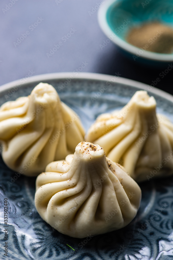 Traditional georgian khinkali dish on stone background Traditional georgian khinkali dish on stone background