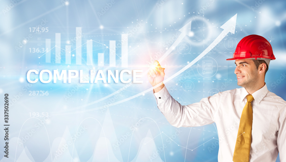 Young businessman with helmet drawing COMPLIANCE inscription, modern business technology concept Young businessman with helmet drawing COMPLIANCE inscription, modern business technology concept