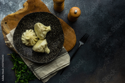 Traditional georgian khinkali dish on stone background photo