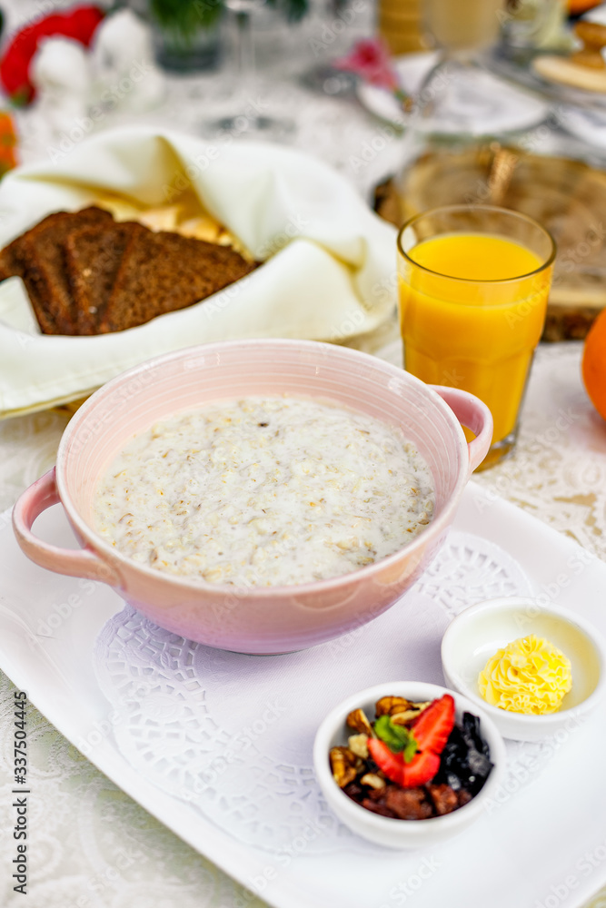 breakfast, oatmeal with butter, berries and orange juice breakfast, oatmeal with butter, berries and orange juice