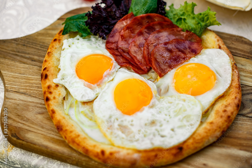 Bacon and eggs on a wheat cake with greens for lunch Bacon and eggs on a wheat cake with greens for lunch