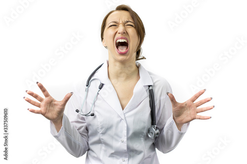 Beautiful young female doctor in white medical coat and stethoscope crazy and mad shouting and yelling with aggressive expression and arms raised. Frustration concept, isolated white background