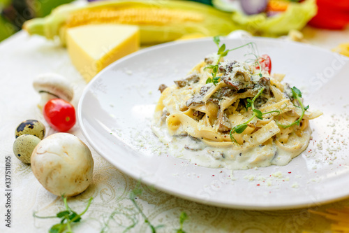 Spaghetti Carbonara - pasta with smoked bacon and mushrooms in creamy sauce and Parmesan cheese
