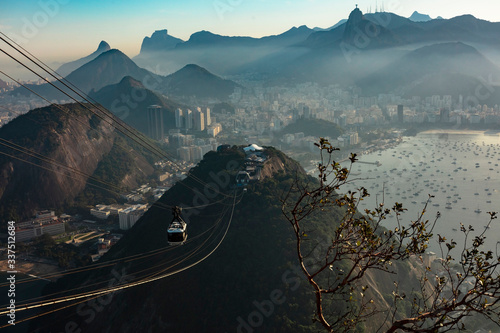 Panoramic aerial view of Guanabara Bay, statue of Christ the Redeemer and sugar loaf mountain with cable car at sunset, Rio de Janeiro, Brazil.