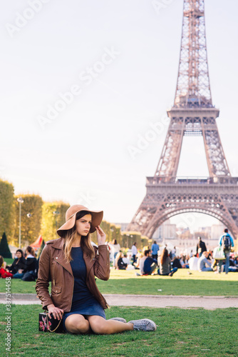 girl sitting in Paris against the backdrop of the Eiffel tower © Aleksei Zakharov