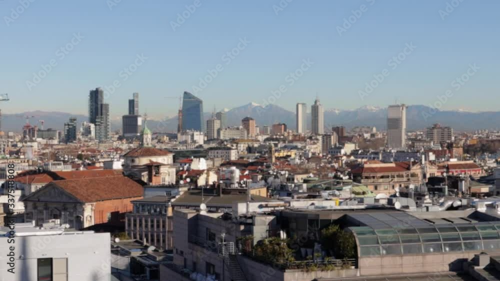 Panorama wide view of milan cityscape during bright sunny day from the top of the duomo di milano cathedral Panorama wide view of milan cityscape during bright sunny day from the top of the duomo di milano cathedral