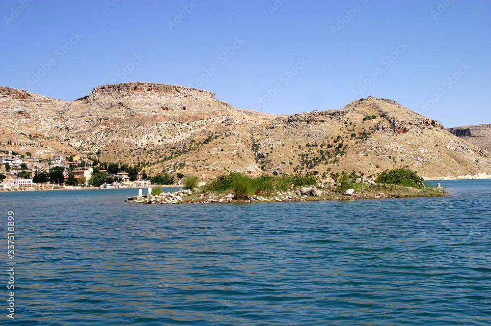 Sunken village Savasan and small cemetery island in Euphrates River (Firat), Halfeti, Gaziantep, Turkey.