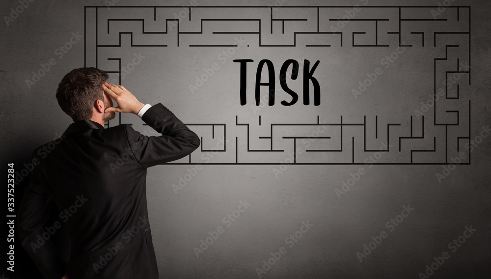 businessman drawing maze with TASK inscription, business education concept