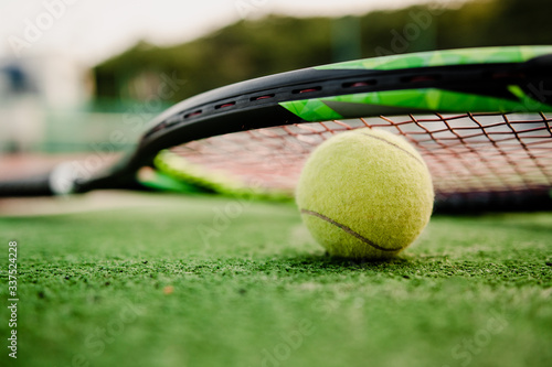 tennis ball with racket on court during day photo