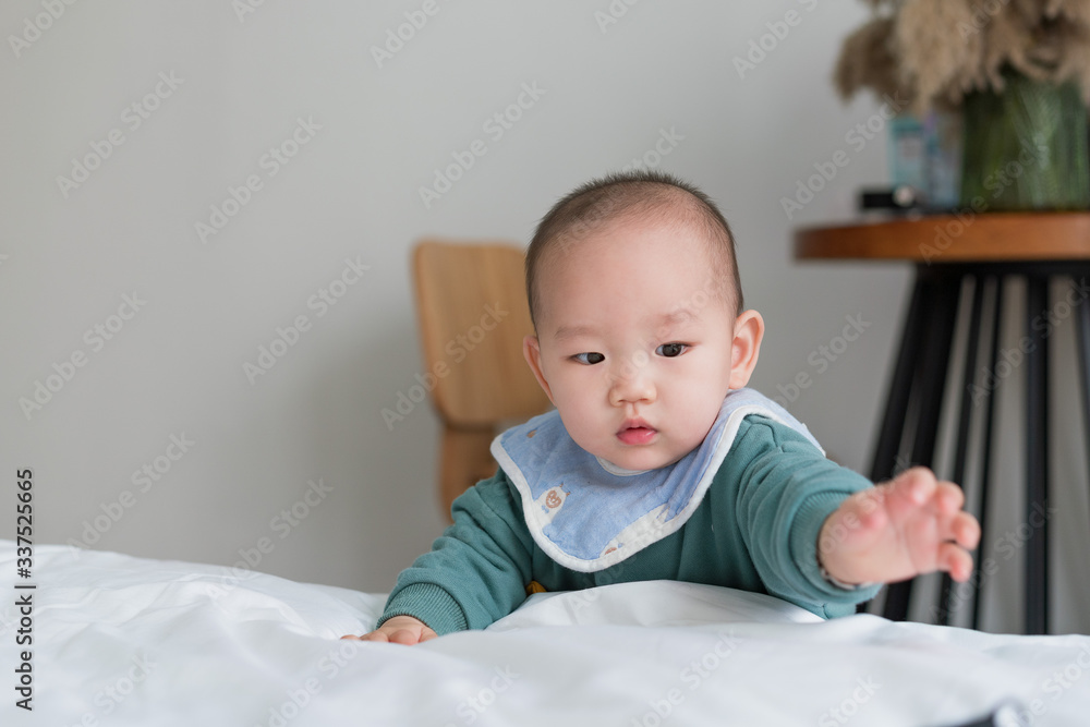 Asian baby in the room reaches for something Asian baby in the room reaches for something