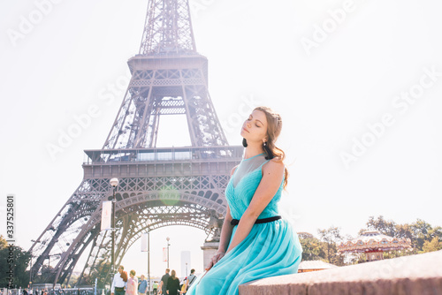 Beautiful young woman near the Eiffel tower in Paris © Aleksei Zakharov