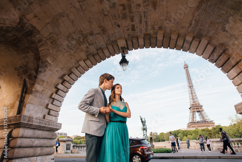 A romantic couple of lovers meet near the Eiffel tower.Paris, France