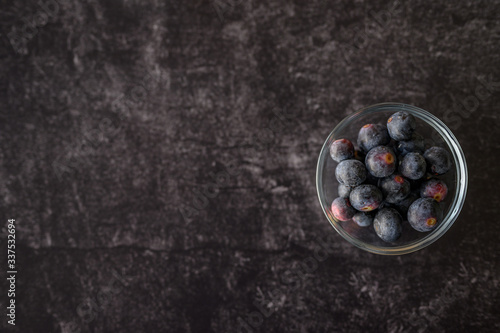 bowl of blueberries in glass bowl on black slate cutting board