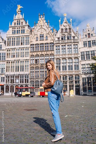 Young woman tourist walking on the Great Market square during the morning in Antwerpen