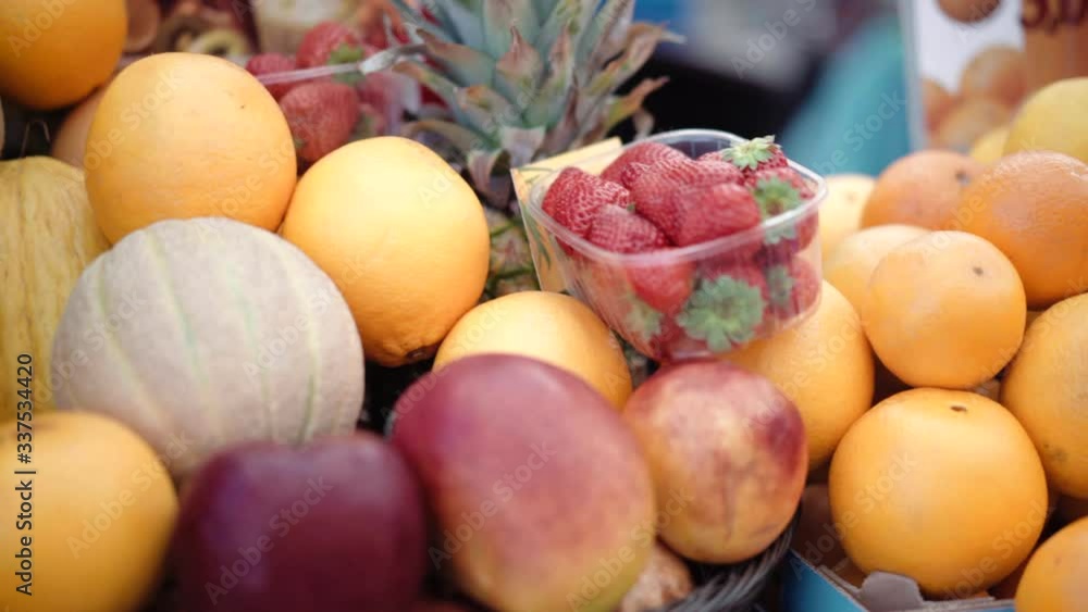 Exotic fruits at the local farmer's market, tasty ripe oranges, lemons, kiwi, watermelons, melons, strawberries and pineapples at the market counter. Ripe fruit sale Exotic fruits at the local farmer's market, tasty ripe oranges, lemons, kiwi, watermelons, melons, strawberries and pineapples at the market counter. Ripe fruit sale
