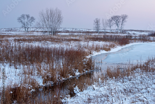 A winter day ends with a peaceful twilight on a Midwest prairie landscape.