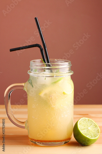 lime and lemon cocktail. non alcoholic citrus summer drinks with citrus on wooden table. Deliciouse nature summer refreshing drink in glass.