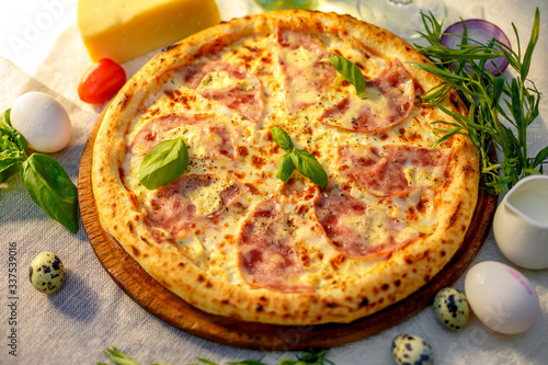 Delicious italian pizza served on table with ingredients cheese and vegetables