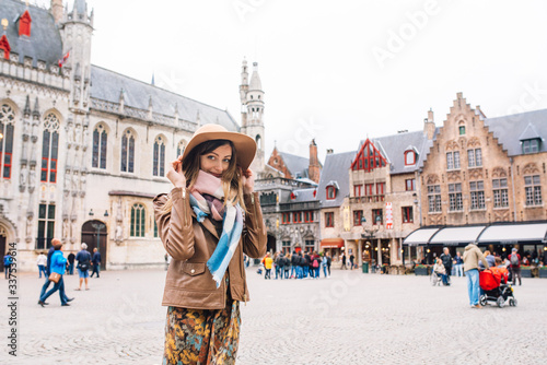 a girl looks at a historic building in Bruges