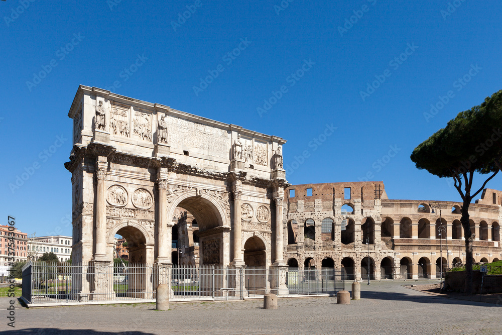 The Arch of Constantine (Arco di Costantino). .Triumphal arch and Colosseum on background. Rome, Italy