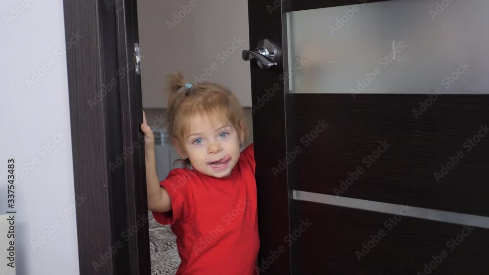 lifestyle boy playing indulges concept. little boy shows tongue. the child opens the door to indoors the room lifestyle boy playing indulges concept. little boy shows tongue. the child opens the door to indoors the room