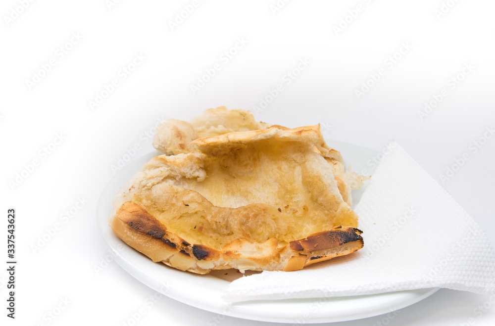 Popular brazilian bread with melted butter called pao na chapa. Pao na chapa traditional brazilian breakfast. Glass of hot coffee with milk called pingado. 