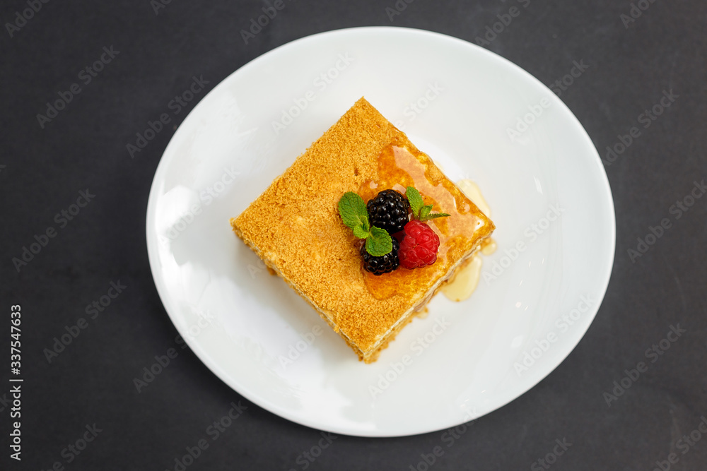 a slice of honey cake with berries, sweet dessert a slice of honey cake with berries, sweet dessert