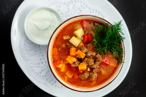 hot soup with broth and stew with vegetables