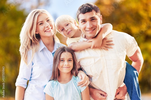 Beautiful smiling lovely family on outdoor background