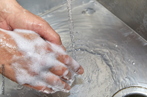 A Man's Hands with Soap and Water on Them