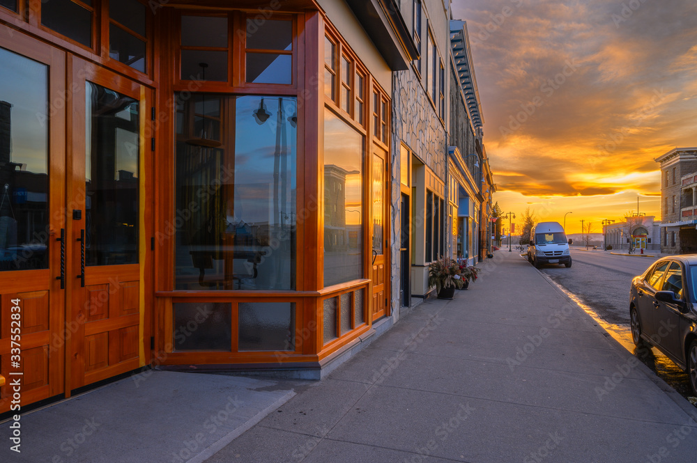 Sunset reflected in store front windows of Fort MacLeod, Alberta, Canada