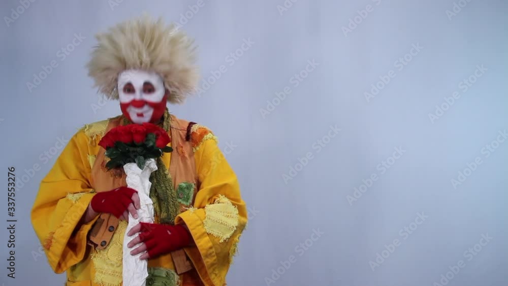 Cute clown gives you bouquet of roses Cute clown gives you bouquet of roses