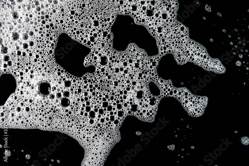 White foam bubbles on a black background