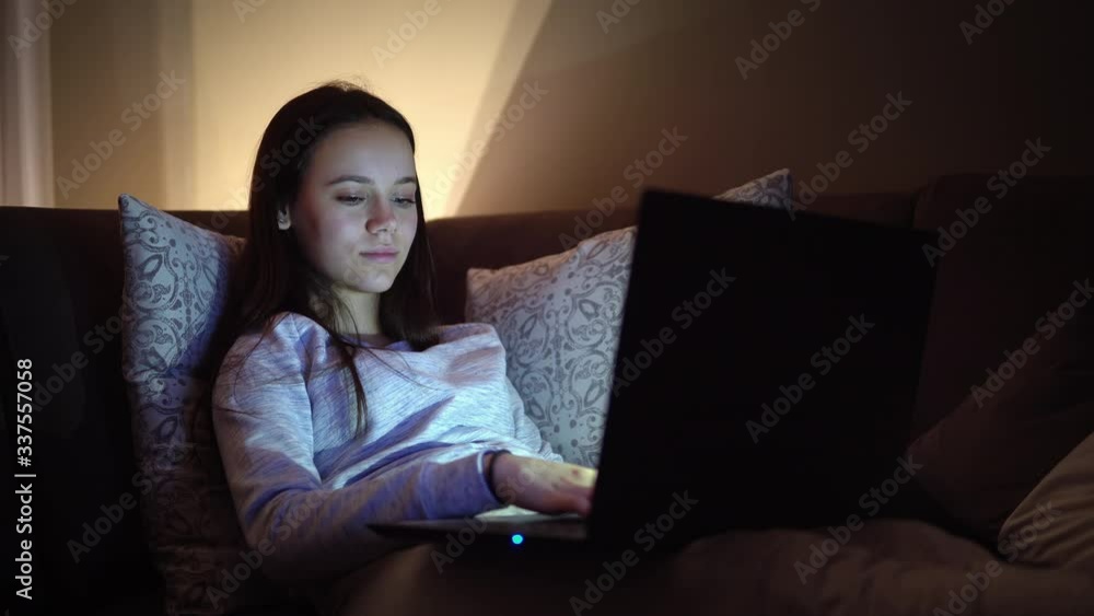Work during quarantine, a female teen at home works on the laptop doing distance education during corona virus quarantine Work during quarantine, a female teen at home works on the laptop doing distance education during corona virus quarantine