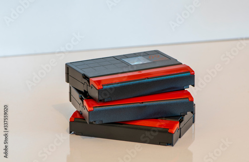 Mini DV tapes, stacked and isolated. Old video recording medium. Obsolote data storage technology from 1990s. photo