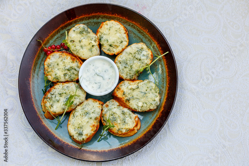 garlic bread with raw greens and sauce on a decorated table