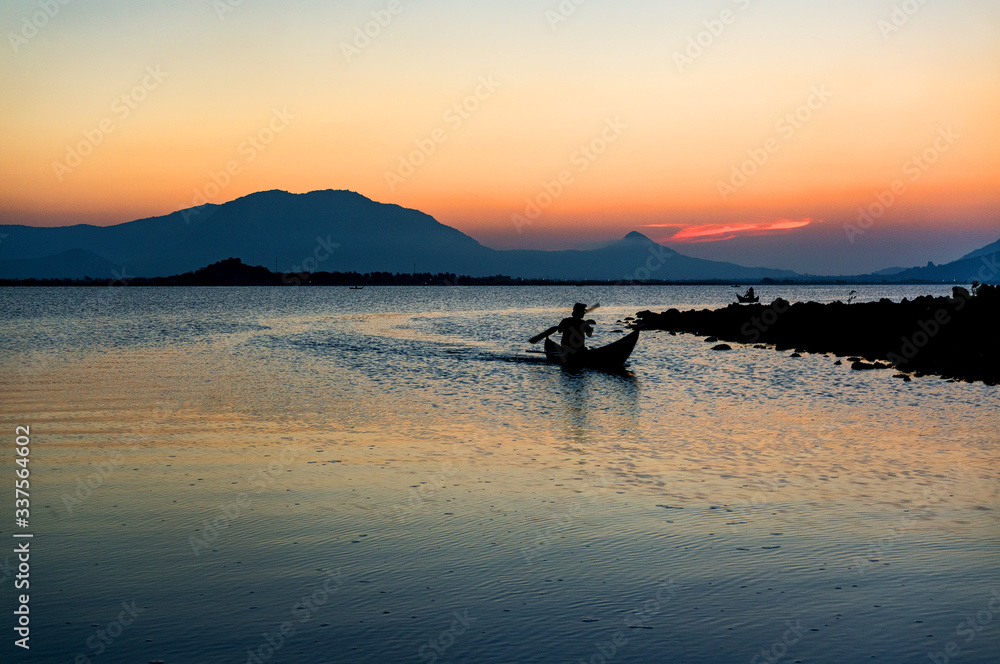 Traditional Boat and location fisherman on the beach at sunrise time, Hon Thien village, Phan Rang, Vietnam