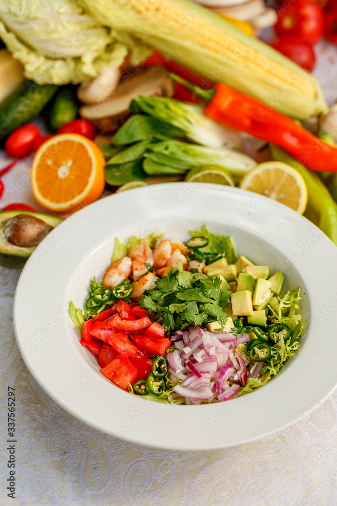Salad with shrimps and vegetables, healthy food on the decorated table