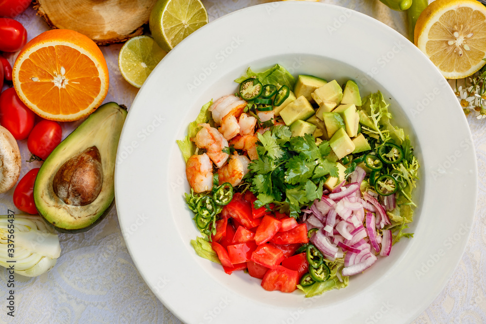 Salad with shrimps and vegetables, healthy food on the decorated table Salad with shrimps and vegetables, healthy food on the decorated table
